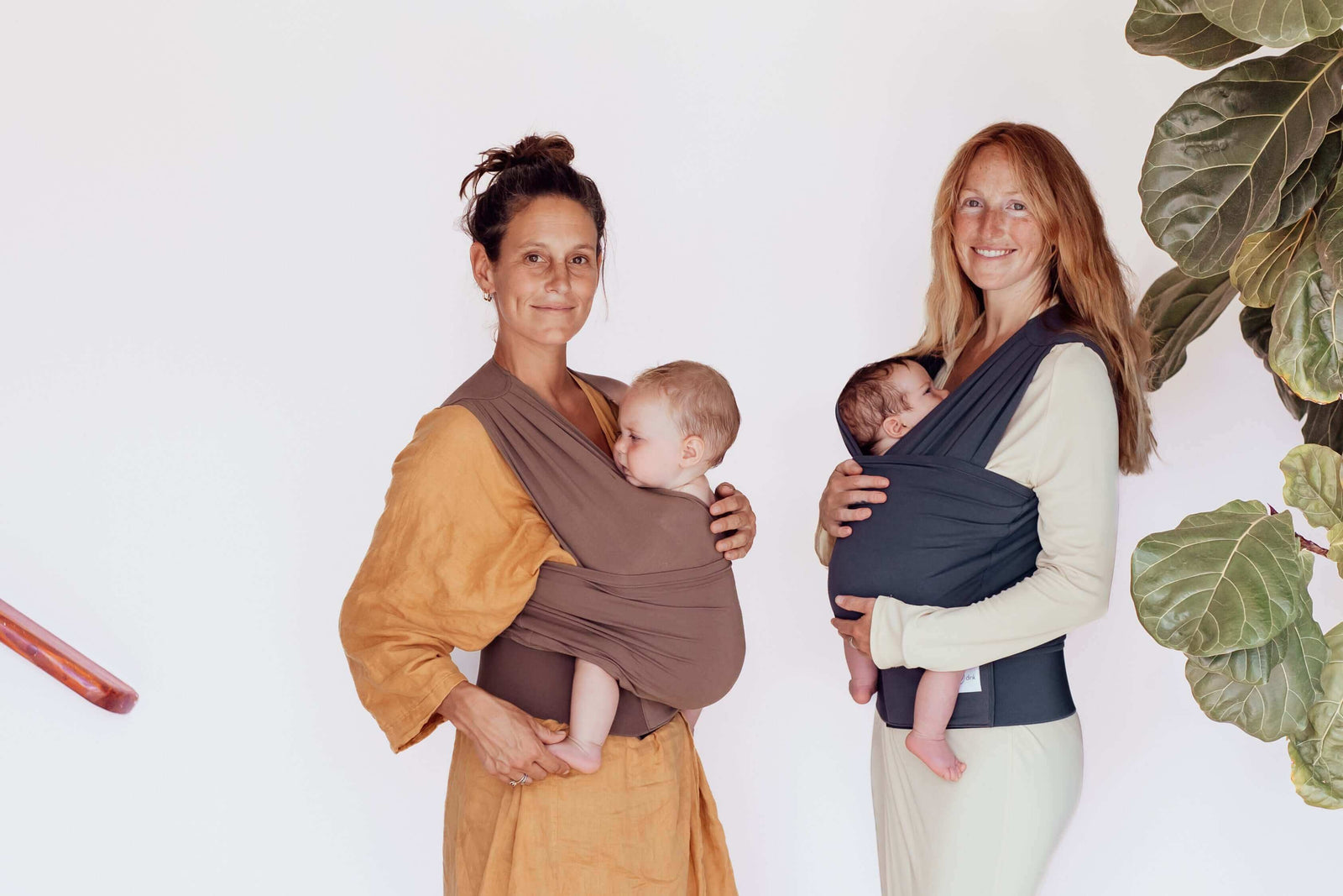 Two mums wearing BabyDink carrier in color brown and blue