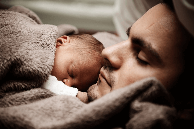 A father co-sleeping with baby