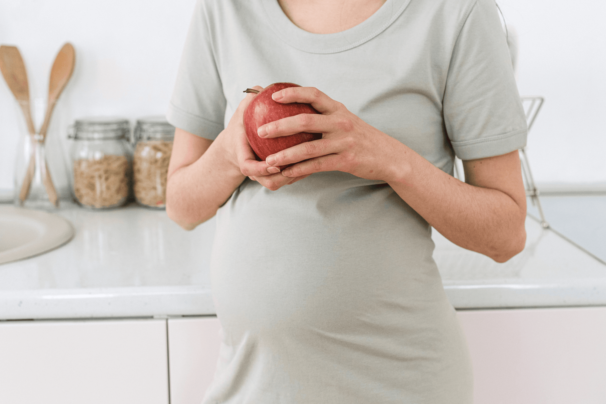 Pregnant woman holding a Fruit