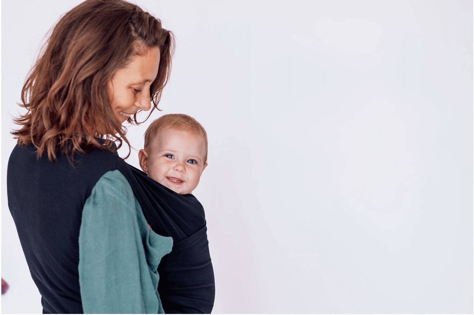 Bubs and Mum wearing BabyDink Carrier in Color Black