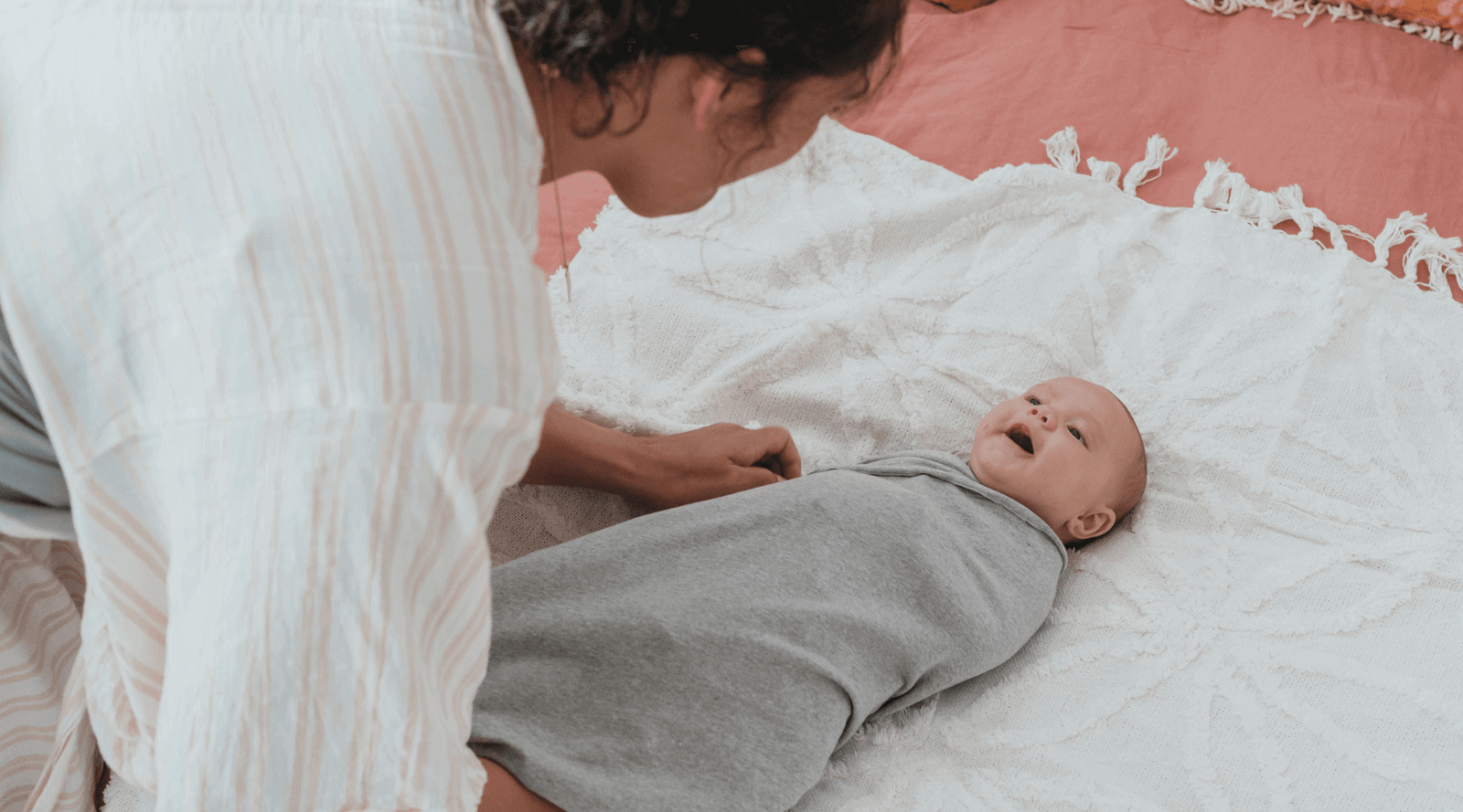 Mother swaddling her baby