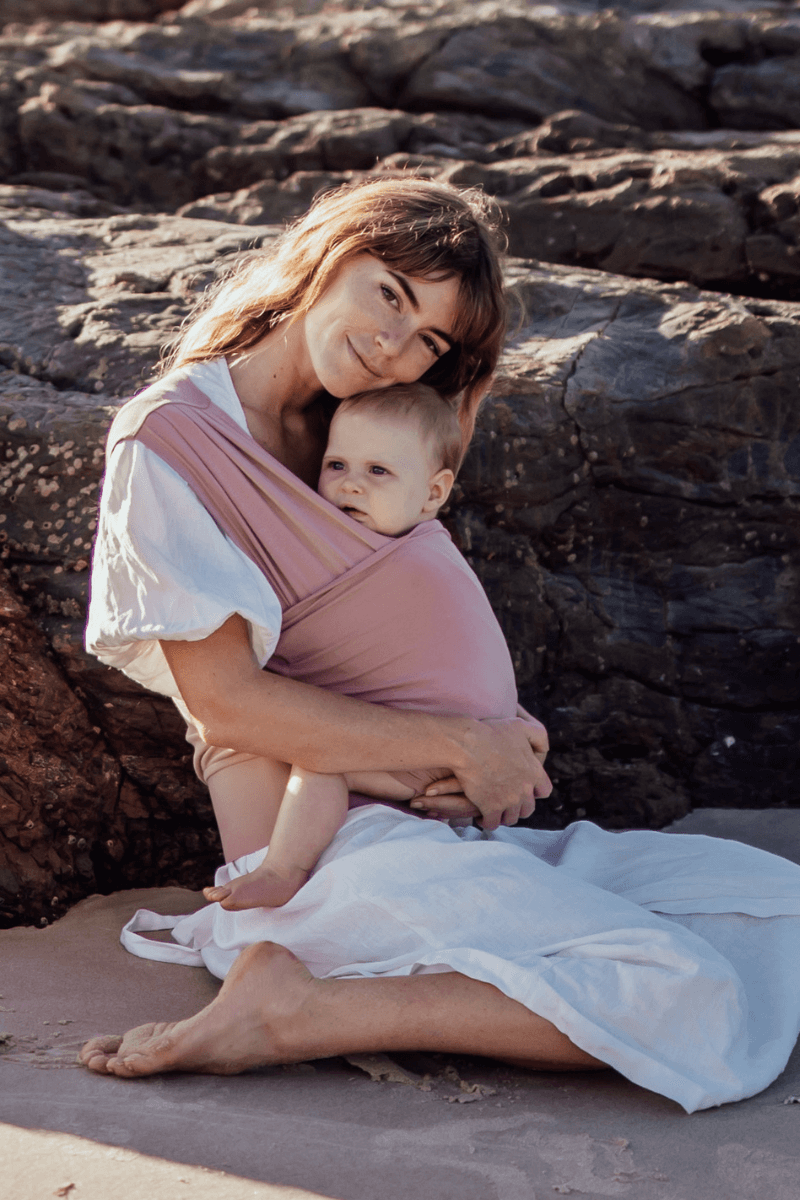 Newborn Baby Carrier in Pink Color worn by a Parent 