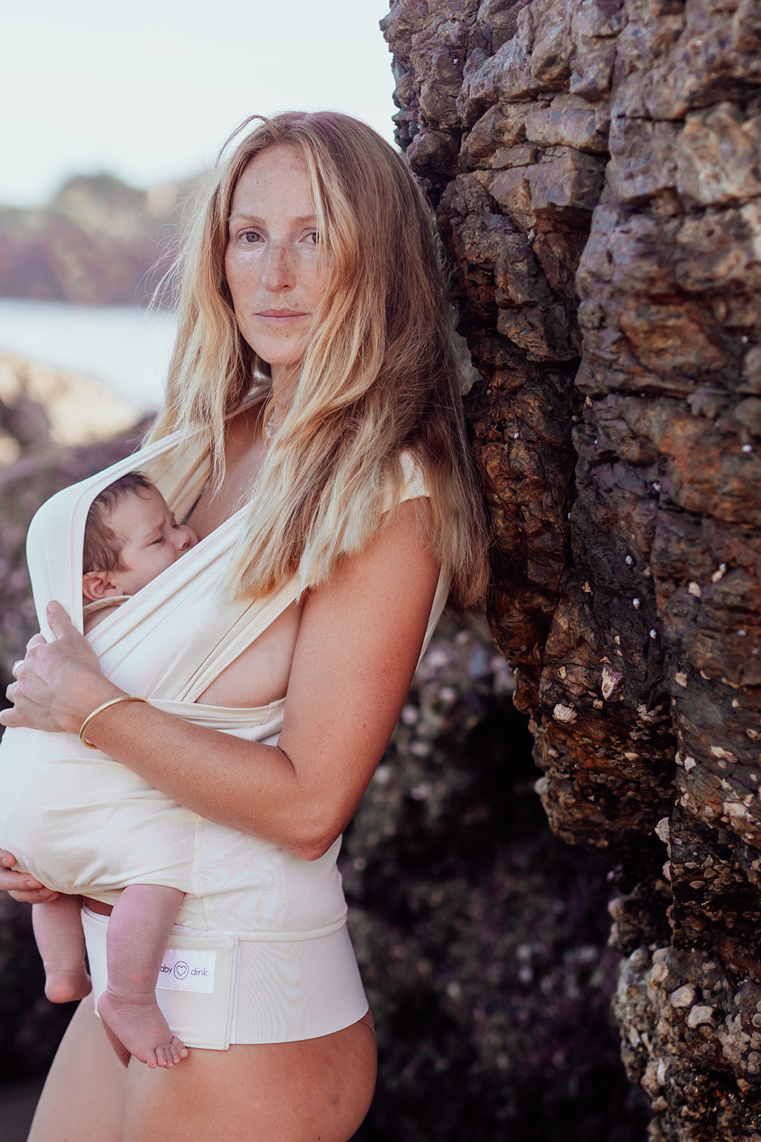Newborn Baby Carrier in Sand Color worn by a Parent 